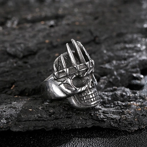 Detailed close-up of a vintage skull ring with crown in oxidized gothic steel style