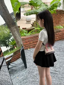Outdoor-Ansicht einer Mini-Mädchen-Umhängetasche mit rosa Griff und Trikolore-Patchwork