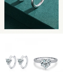 Macro shot of S925 sterling silver heart-shaped zircon ring and matching earrings set