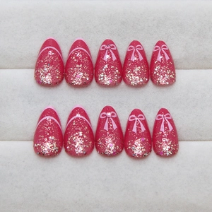 French style fuchsia press-on nails with glitter ombre and bow tie rhinestone details