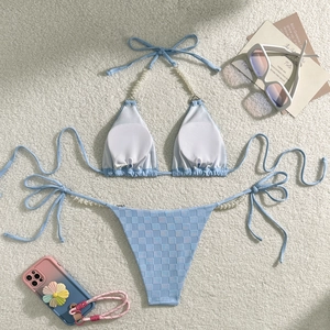 Close-up of light blue checkered bikini with elegant pearl shoulder strap details