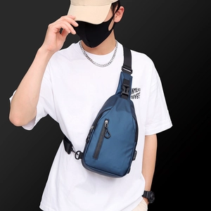 Navy blue men's casual crossbody chest bag in premium nylon material worn by model