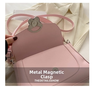 Detail of pink vintage underarm bag featuring secure metallic magnetic buckle closure