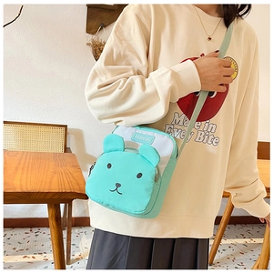 Detail of cute mint green cartoon crossbody bag with 3D ears and adjustable strap