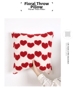 Detailed view of red plush heart on cream velvet throw pillow with soft grainy texture