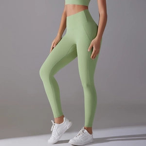 Detail view of high-waist green yoga pants with seamless stitching and elastic compression