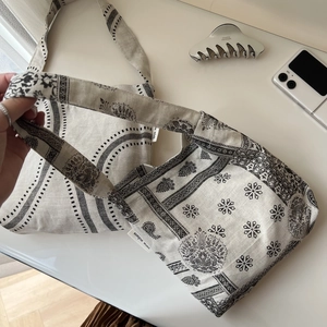 Detailed shot of ethnic patterned cotton linen tote bags with simple wish woven label