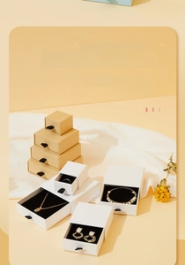 Detail of drawer jewelry boxes with black ribbon pull and soft velvet inner padding