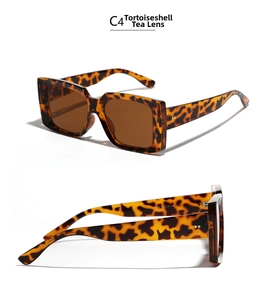 Macro detail of tortoiseshell square sunglasses with metal rivets and tea-tinted lenses