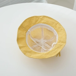 Detail of yellow baby sun hat with breathable mesh lining and adjustable drawstring