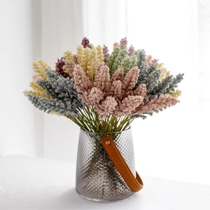 Artificial grain wheat stalks in various colors with a glass vase for home decoration