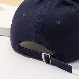 Detail shot of the navy cotton twill cap featuring a high-quality metal adjustment buckle
