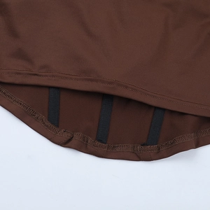 Detailed macro view of dark brown lace corset top hem with black supportive boning