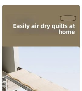 Detail of wall-mounted telescopic drying rack holding a heavy yellow quilt on balcony