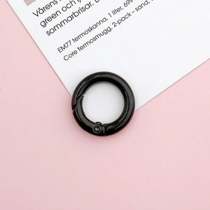 Macro detail of glossy black 20mm metal spring ring connector for DIY handbag accessories