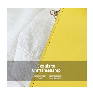 Close-up of bright yellow leather bag edge with fine stitching and golden metal hardware