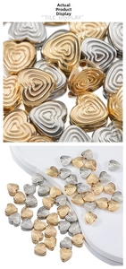 Macro view of gold and silver CCB heart-shaped beads with concentric groove texture