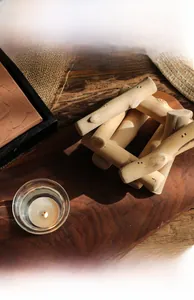 Detalle de portavelas de madera con vaso de vidrio extraíble y vela de té caliente