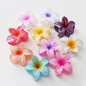 Set of ten colorful 8cm plumeria flower hair claws with gradient petals on white background