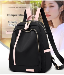 Detail of waterproof nylon backpack with black and pink contrast and gold metal zippers