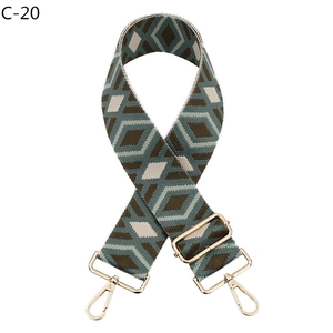 Detail of adjustable geometric diamond pattern wide bag strap with gold metal hooks