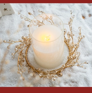 Golden beaded candle ring set with glass holder and LED candle on snow background