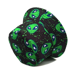Reversible black bucket hat with neon green alien graphic and ink splatter street style