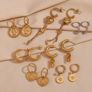 Detail showing 18K gold plated heart, coin, and crescent moon charms on earrings