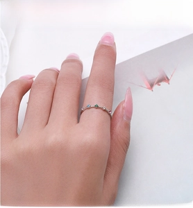 Macro shot of colorful zircon stones on S925 sterling silver ring worn by model