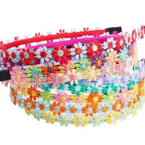 Detailed embroidery of colorful daisy flower headbands with soft fabric finish