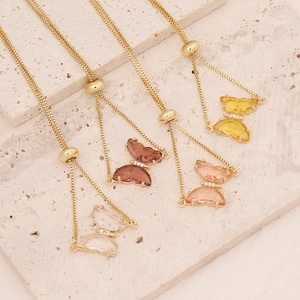 Detail of 18K gold plated bracelet with adjustable slide buckle and crystal butterflies