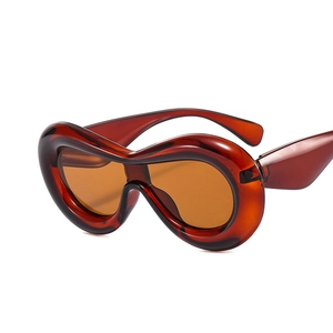 Y2K wavy oversized wrap-around sunglasses in amber brown translucent resin finish