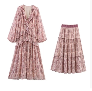 Close-up of paisley print chiffon V-neck tiered dress with ruffle details and bishop sleeves