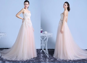 Detail view of pink gradient tulle evening gown featuring lace bodice and corset back