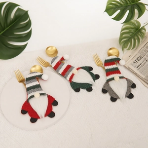 Set of 3 Christmas gnome cutlery holders in red, green and grey on a festive table