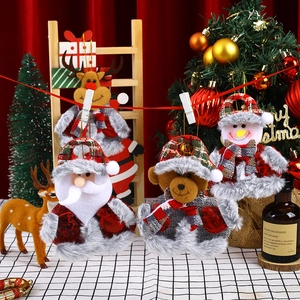 Three Christmas plush ornaments with Santa, bear, and snowman featuring red plaid hats