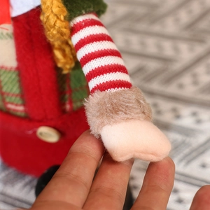 Detail of Christmas elf doll showing striped knit sleeve and soft faux fur cuff texture