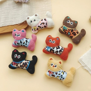 Close-up of cute leopard print plush kittens for DIY hair accessories and brooches