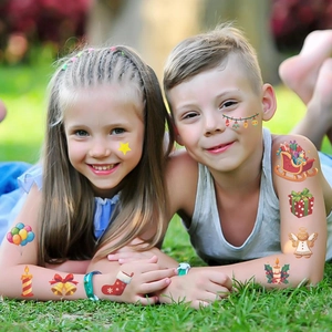 Kids Christmas temporary tattoos featuring festive patterns applied on skin in outdoor setting