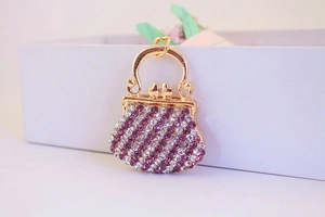 Close-up of gold alloy handbag keychain with purple and clear rhinestones for bags