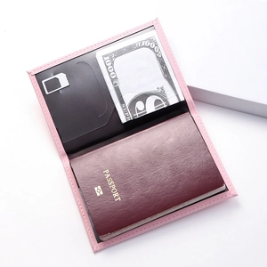 Detail view of the pink PU leather passport holder interior with card and SIM slots