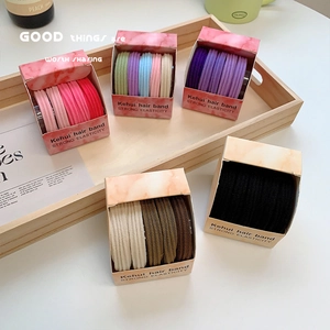 Colorful high-elastic ribbed hair bands set in a wooden tray with clean minimalist styling