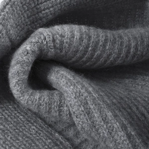 Thick dark grey wool knit fabric texture detail showing soft fibers and warm weave