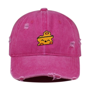 Close-up of pink distressed baseball cap with cute cheese embroidery and ripped details