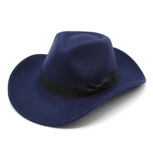 Detail of navy wool cowboy hat showing wide brim and black ribbon bow decoration
