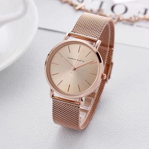Elegant rose gold women's watch with mesh strap and minimalist round dial on white texture