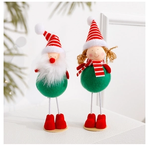 Detail of felt and plush Christmas Santa and girl dolls for holiday scene decoration