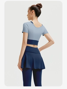 Back view of high-elasticity yoga set featuring a blue crop top and skirted leggings