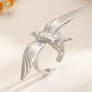 Detailed close-up of a silver swallow bird ring featuring intricate feather carvings