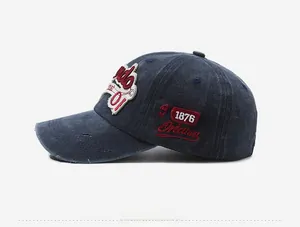 Detail view of vintage denim baseball cap with 1876 embroidery and distressed edges